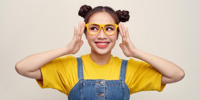 Portrait of the beautiful happy young woman in glasses isolated on white background