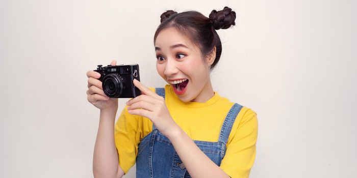 Woman using photo camera in studio