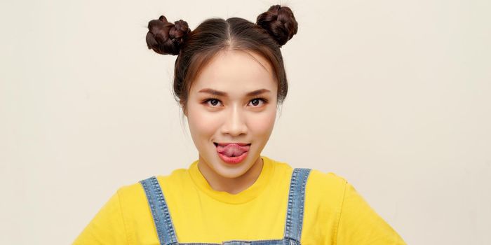 Pretty girl having fun showing tongue isolated over white background