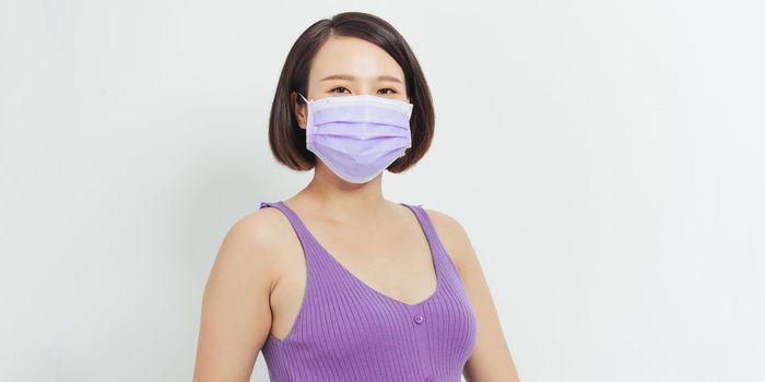 Young pregnant woman mother to be wearing protection mask for coronavirus disease