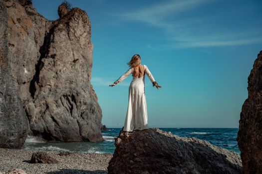 Middle aged woman looks good with blond hair, boho style in white long dress on the beach decorations on her neck and arms