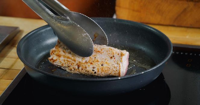 Pork Meat Frying in Hot Pan. Close Up cooking Professional Delicious Meat.