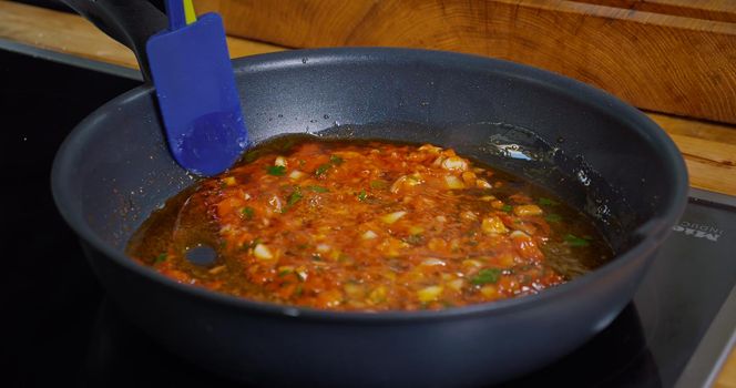 Preparing a Sauce from Tomato Paste and Onion at pan. Appetizing Food Process