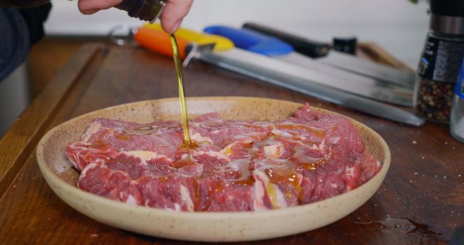 Seasoning Raw Beef Meat. Close Up Cooking Beef Meat. Professional Meat Cooking.