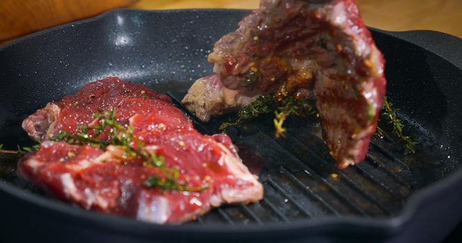 Appetizing Beef Steak cooking in a pan seasoned with herbs. Cooking Art Food Meat Meal Tasty