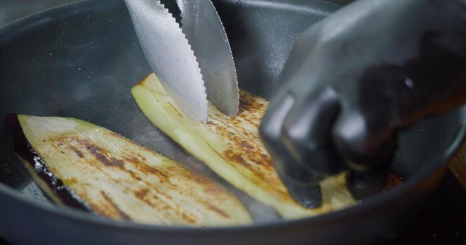 Close Up Fried Sliced Eggplant in Pan. Delicious Vegetables. Tasty Vegetarian food.