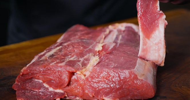 Cutting Portions of Fresh Raw Beef Meat As Preparation Before Cooking. Food Art.