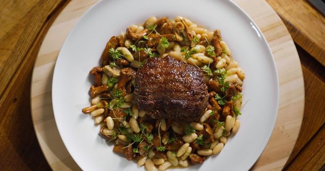 Top View of Food. White Plate with delicious Beef Food dish. Food Preparation