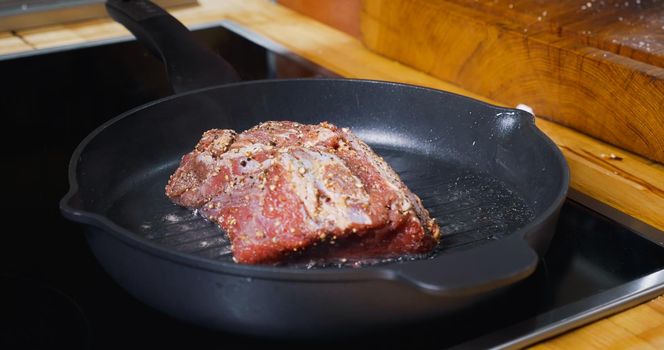 Delicious Juicy Meat Steak Cooking on Grill. Hot Pan.