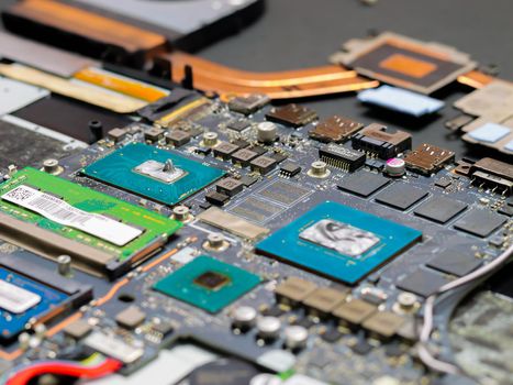 Thermal paste compound squeezing on processor and graphics processor of notebook. Thermal grease for better cooling of device. Cooling upgrade concept.