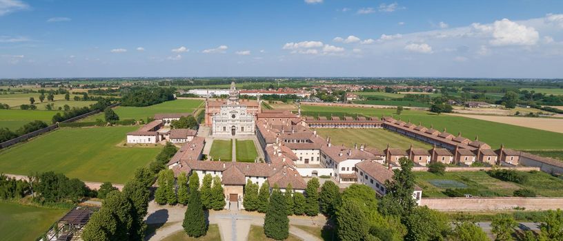 Aerial view of the Certosa di Pavia at sunny day, built in the late fourteenth century, courts and the cloister of the monastery and shrine in the province of Pavia, Lombardia, Italy