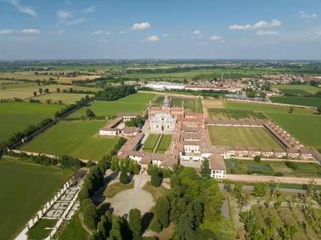 Aerial view of the Certosa di Pavia at sunny day, built in the late fourteenth century, courts and the cloister of the monastery and shrine in the province of Pavia, Lombardia, Italy