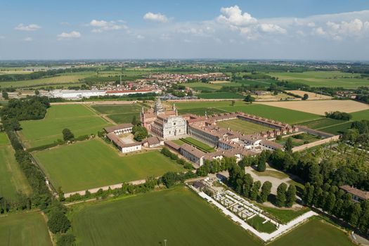 Aerial view of the Certosa di Pavia at sunny day, built in the late fourteenth century, courts and the cloister of the monastery and shrine in the province of Pavia, Lombardia, Italy