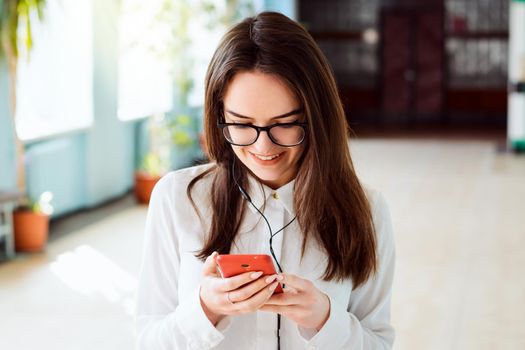 Student listens to music in university building during the way to the lecture