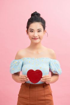 Woman holding paper heart shaped card . Valentine day concept .
