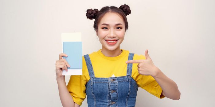 beautiful tourist woman holding passport id with surprised face pointing finger to herself