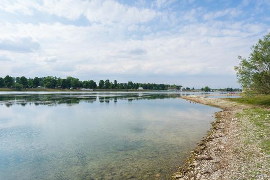 Nice view of Idroscalo lake park, on the left the stands, on the right a quay where young boys and girls prepare their canoes to training.