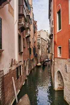 Venice, Italy - 10.12.2021: Traditional canal street with gondolas and boats in Venice, Italy. High quality photo