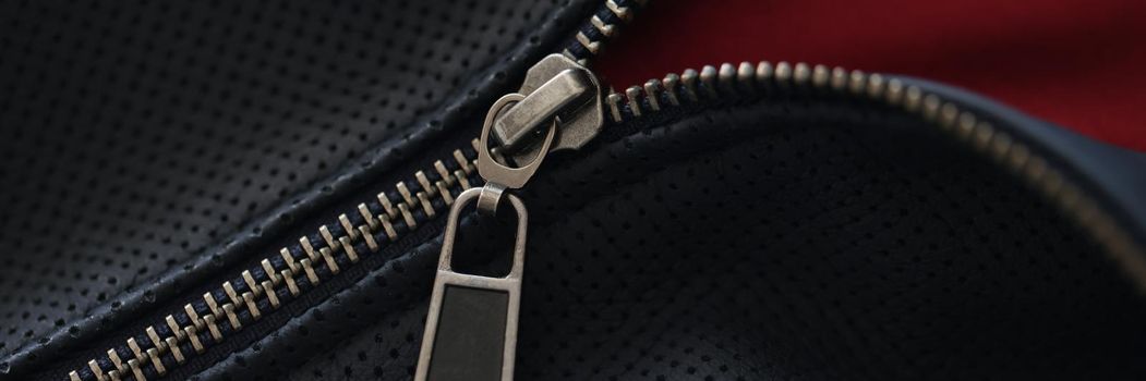 Closeup of zipper on blue leather jacket. Leather clothing repair concept