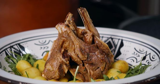 Lamb Ribs Meat Dish Served with Vegetables and Arugula.