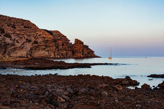 Typical beach with lava in the sea of Linosa one of the Pelagie Islands in the Sicily Channel of the Mediterranean Sea