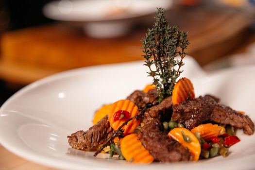 Beef Meal Presentation on White Plate Close Up. Chef Specialty Dish.