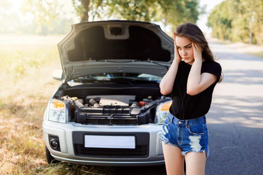 Girl driver sad because of her car breakdown in the middle of nowhere and she doesn't know how to get home
