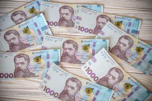 Close up 1000 Ukrainian money hryvnia on white background. Business flat lay with copy space for text. Crisis and problem of financial turbulence, inflation, devalvation, economics depression.