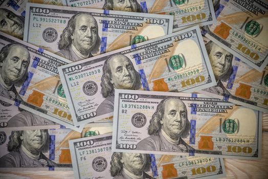 Group of money stack of 100 US dollars banknotes a lot of the background texture top view.