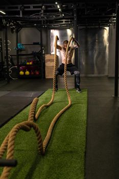 Rope man grass warehouse green fitness training gym exercising exercise, for athlete one from male from healthy moving, sport muscle. Standing ground holding, lifestyles