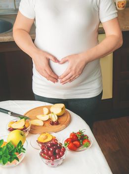 A pregnant woman eats fruit. Selective focus. food.