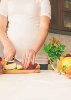 A pregnant woman eats fruit. Selective focus. food.