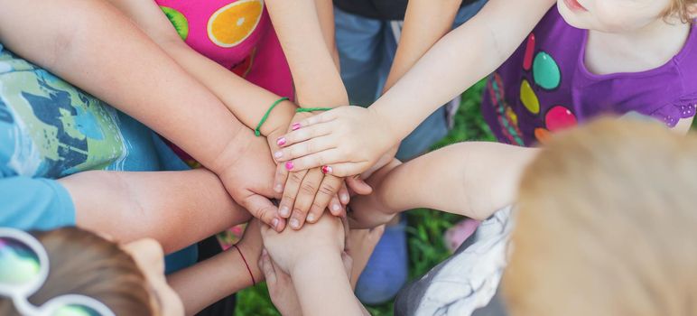 Children's hands together, street games. Selective focus. Kids.