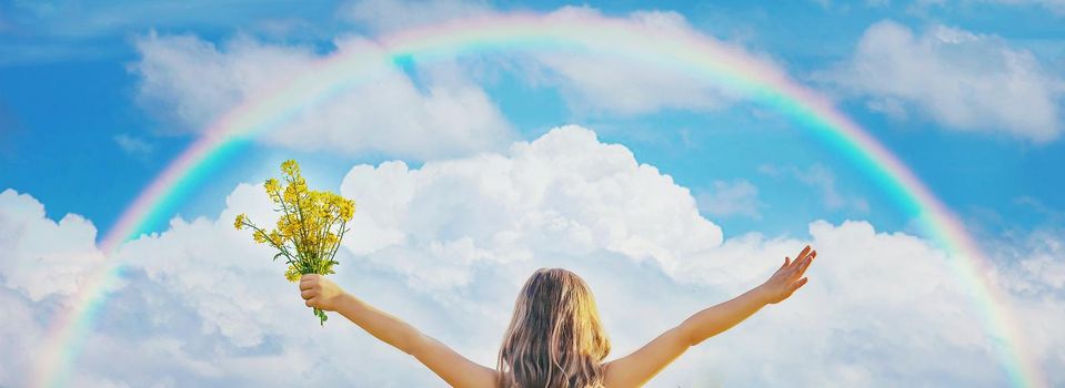 A child in a yellow rainbow field. Selective focus. nature.