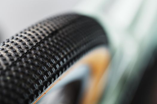 Shallow tread of a bicycle tubeless tire with a brown sidewall close-up
