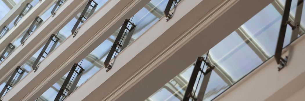 Facade of multistorey building with glass balconies closeup background. Urban architecture concept