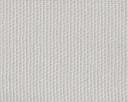 Woven glass fiber wallpaper against a light background. Combination looks like beige.