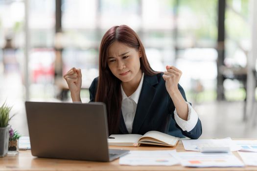 Digital Online meeting concept. Asian Business woman having conference with her partners by laptop computer at office