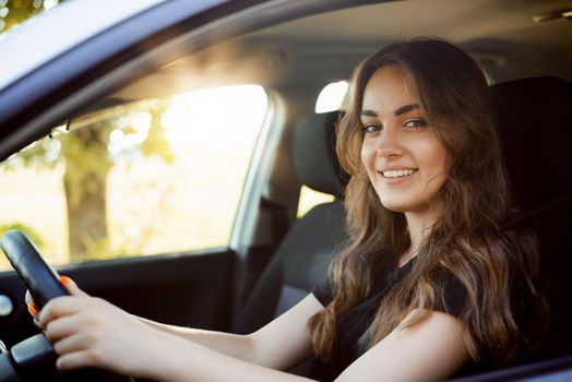 Happy female student driving car, happy to pass driving exam and drive car by herself