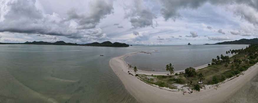 couple of men and women walking on the beach at the Island Koh Yao Yai Thailand, beach with white sand and palm trees.