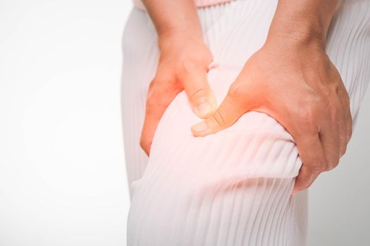 Back view of woman suffering from backache, waist pain, muscle or chronic nerve pain in her back after working. close up. Health problems, concepts of diseases of the musculoskeletal system.