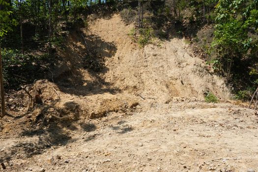 Surface of high soil canyon cliffs has many rounded pebbles scattered in the soil at Pha Chor, a famous tourist attraction in northern Thailand.