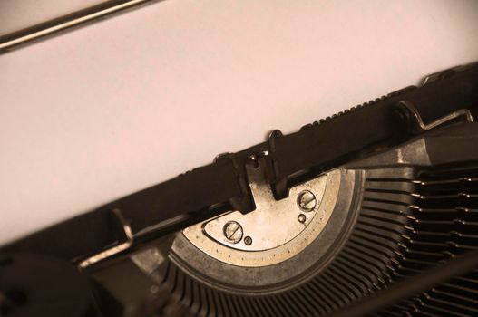 Side view of an old typewriter in vintage color. Copy space.