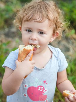 A child eats bread in the park. Selective focus. kid.