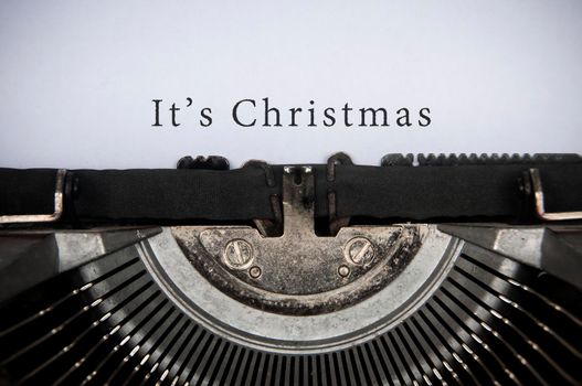 It is Christmas text typed on an old vintage typewriter. Christmas celebration concept