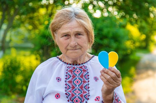 Grandmother in Ukrainian embroidered clothes. Selective focus. Nature.