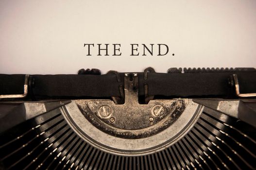 The end text typed on an old vintage typewriter.