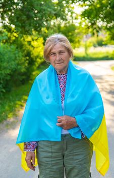 Grandmother in Ukrainian embroidered clothes. Selective focus. Nature.