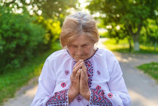 Grandmother in Ukrainian embroidered clothes. Selective focus. Nature.
