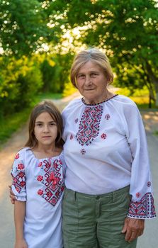 Ukrainian grandmother and granddaughter in vyshyvanka. selective focus. Kid.